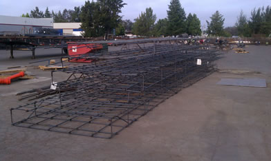 Preassembled retaining wall rebar beams